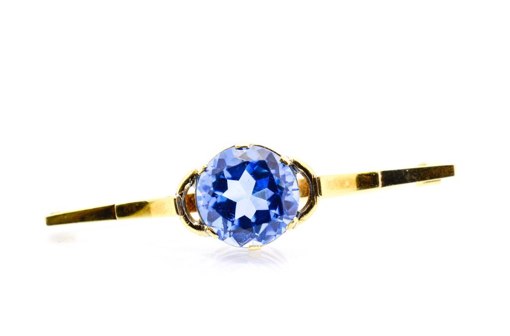 Starožitná zlatá brož s modrým kamenem – topaz